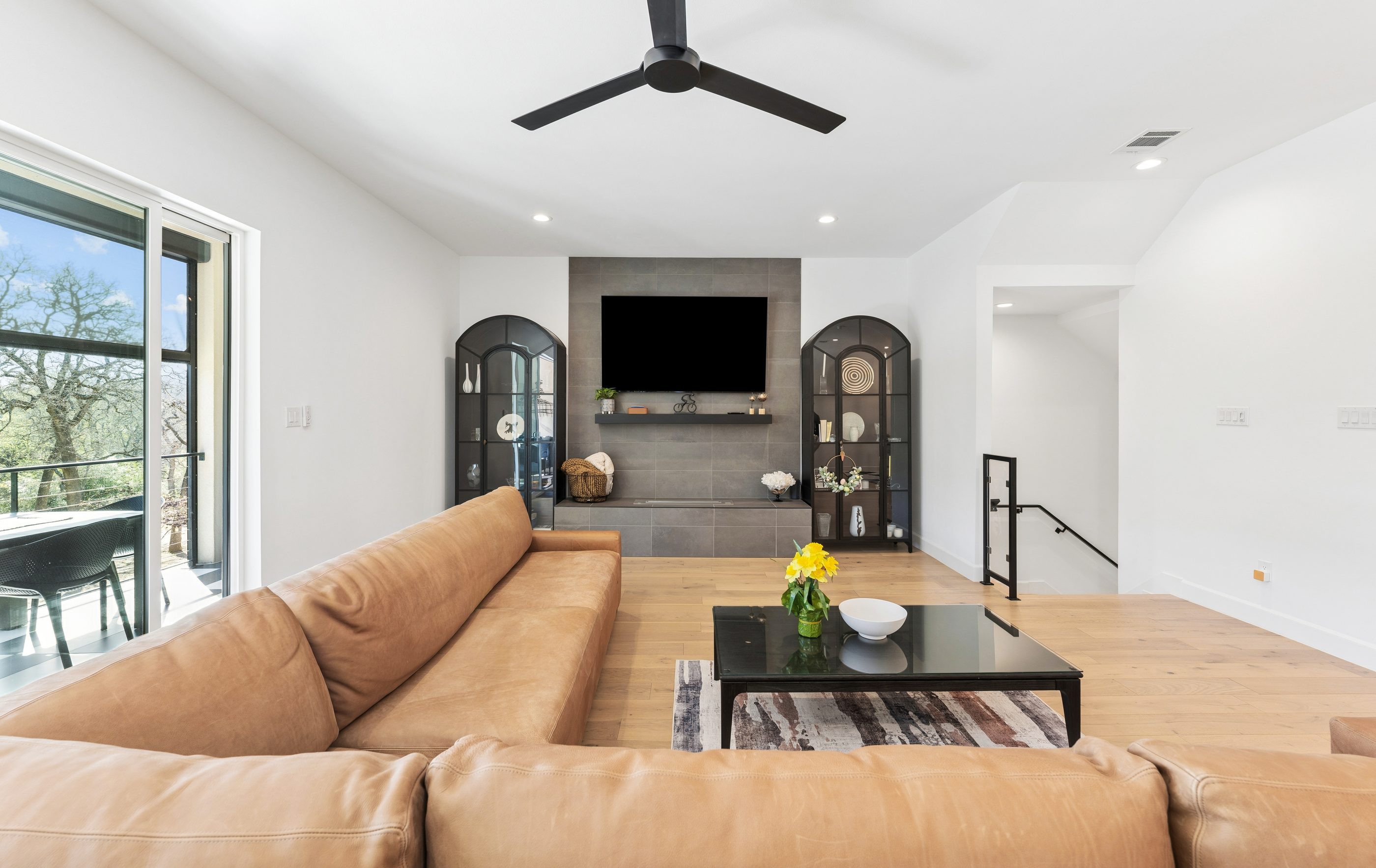 Living room with feature wall and arched cabinets